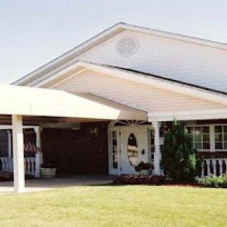 A charming single-story house with a well-maintained front yard and a welcoming entrance.