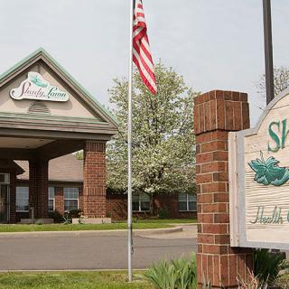 Entrance of a building with an American flag and a sign.