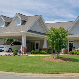 A suburban house with a carport and well-maintained lawn.