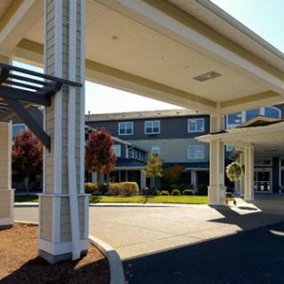 A welcoming entrance to a hotel, showcasing modern architecture and landscaped surroundings.