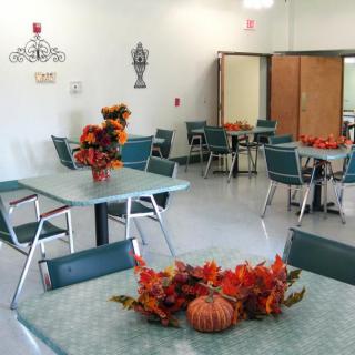 An indoor dining area decorated with autumn-themed centerpieces.