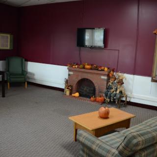 A cozy living room setting featuring a fireplace, television, and comfortable seating.
