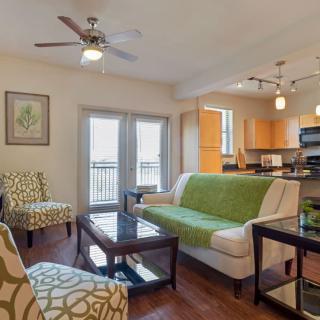 A modern living room with an open floor plan, featuring comfortable seating and stylish decor.