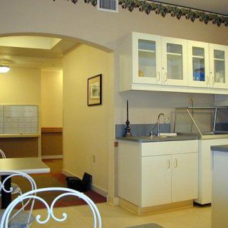 A clean and bright kitchen interior with white cabinets and a sink.