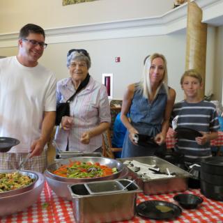 A group of people enjoying a buffet meal at an event.