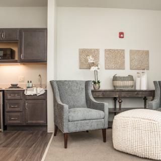 A cozy modern living space featuring a kitchenette and comfortable seating.