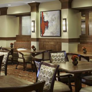 A stylish restaurant interior with elegant seating and artwork on the walls.
