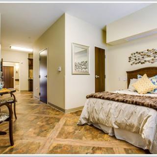 A well-decorated bedroom with modern furniture and wooden flooring.