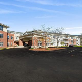 A large residential apartment complex with a driveway and entrance canopy.