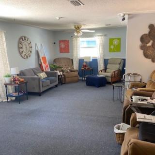 A spacious living room with cozy seating and vibrant wall art.