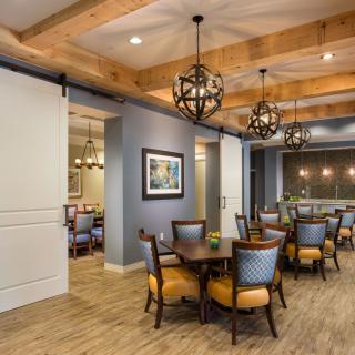 A cozy dining area with elegant chandeliers and comfortable seating.