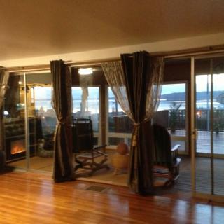 A cozy living room with a fireplace and large sliding glass doors offering a scenic view.