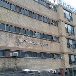 Exterior view of a brick building with prominent signage.