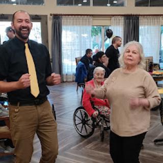 A joyful moment of dancing at a community event, bringing smiles to everyone involved.