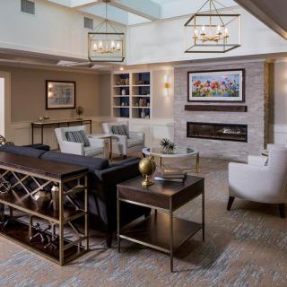 A modern and cozy living room with elegant furniture and a fireplace.
