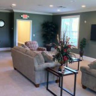 A cozy and well-furnished living room with sofas, a coffee table, and wall decor.
