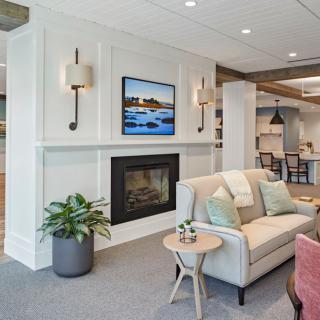 A modern living room with a fireplace, stylish sofa, and elegant lighting.