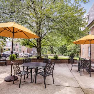 A cozy outdoor patio area with seating and umbrellas, perfect for enjoying the sunshine.