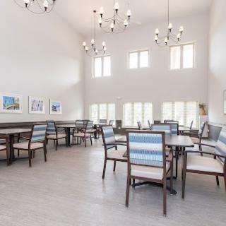 A spacious modern dining area with high ceilings and ample natural light.