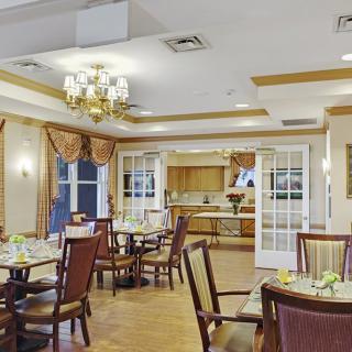 An elegant dining room featuring sophisticated decor with neatly arranged tables and chairs.