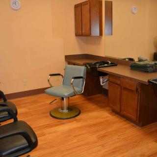 Interior of a barbershop with chairs and mirrors.