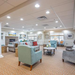 A comfortable and modern living room with ample seating and bright lighting.