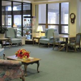 A spacious lobby with comfortable seating and large windows.