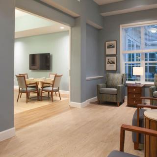 A modern living room and dining area with comfortable seating and sleek furnishings.