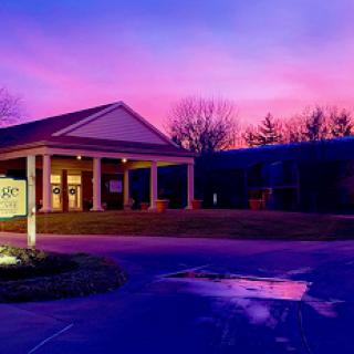 A serene sunset casts a colorful glow over the architectural beauty of the building.