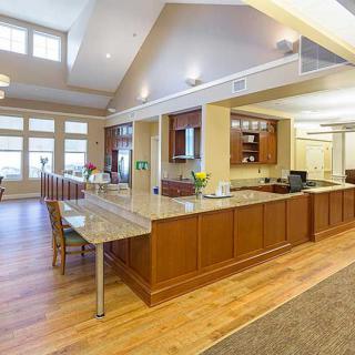 Modern kitchen and dining area with open space and wood flooring.