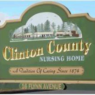 Sign for Clinton County Nursing Home displaying its address and an illustration of the building.