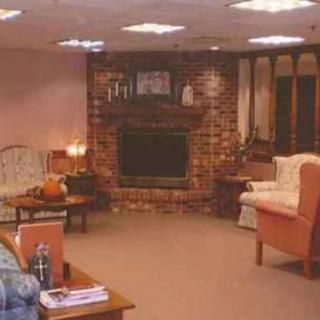 A cozy living room with a fireplace, sofas, and a coffee table.