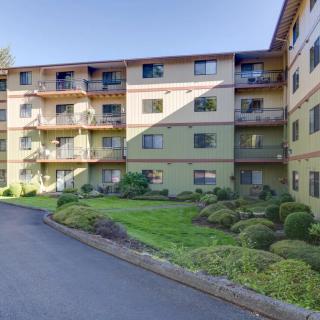 A residential apartment building with well-maintained landscaping and balconies.