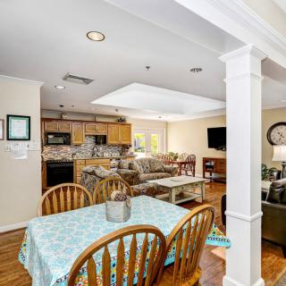 An open concept living space featuring a kitchen, dining area, and cozy living room.