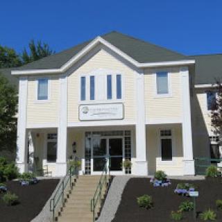 A modern office building with a welcoming entrance and well-maintained landscaping.