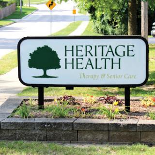 A sign for Heritage Health, indicating a healthcare facility in a community setting.
