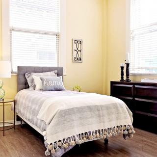 A cozy bedroom with a single bed and modern decor.