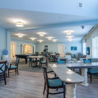 A spacious and well-lit dining area with modern furniture and decor.