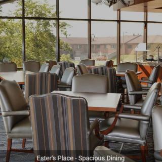 A spacious dining area with ample seating and large windows offering a scenic view.