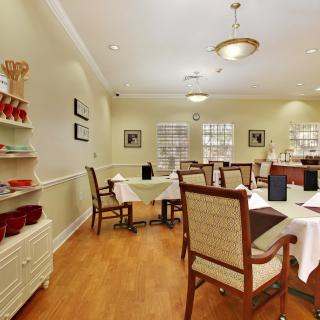 Cozy dining area with neatly arranged tables and chairs.