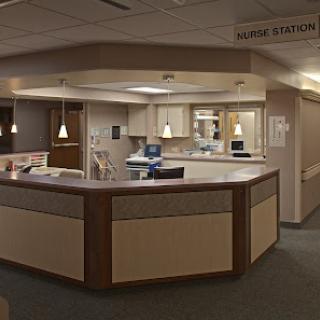 A view of a nurse station in a hospital, featuring a modern and organized reception area.