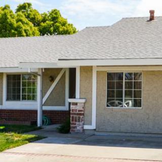A suburban residential house with a front yard.