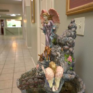 A colorful fairy figurine decorates a hallway.