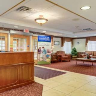 A cozy lobby area with a reception desk and comfortable seating.