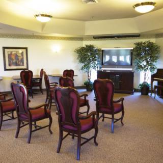 A well-arranged conference room with elegant chairs and a warm atmosphere.