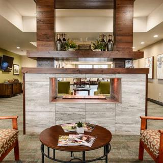 A modern lobby with a central fireplace and comfortable seating.