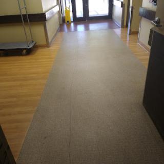 A view of the corridor leading to an entrance in a facility.