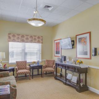 A cozy living room with elegant decor, featuring comfortable seating and warm lighting.