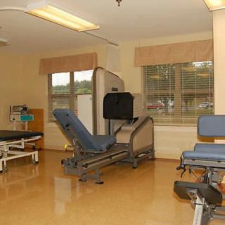 A room equipped with rehabilitation and physical therapy equipment in a medical facility.