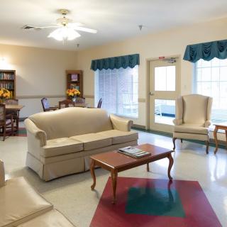 A cozy living room with sofas, armchairs, and a coffee table.